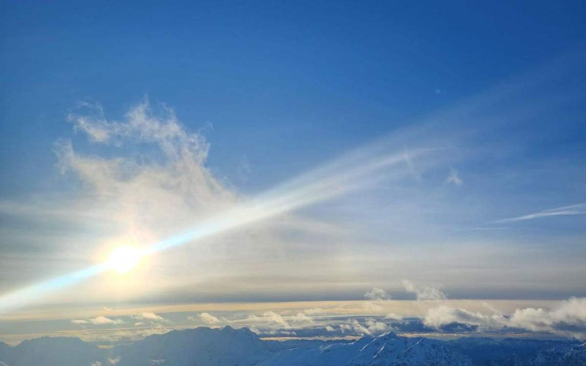 Sunburst over the peaks above Alpe d'Huez