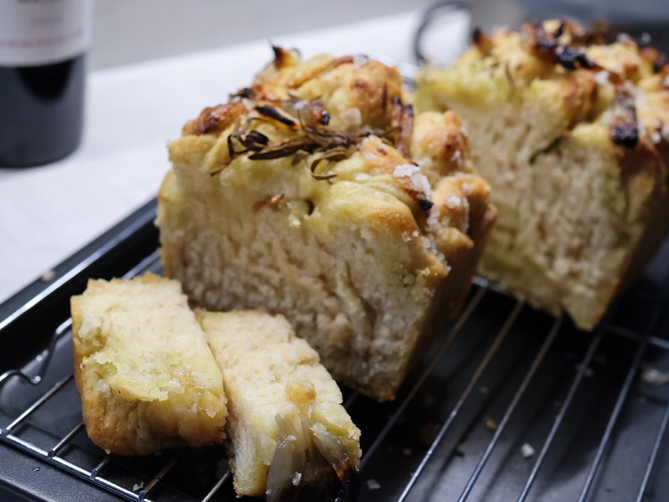 Sliced homemade focaccia with herbs and sea salt